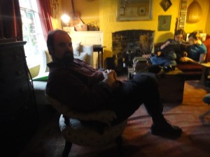 A shadowed man in a little chair